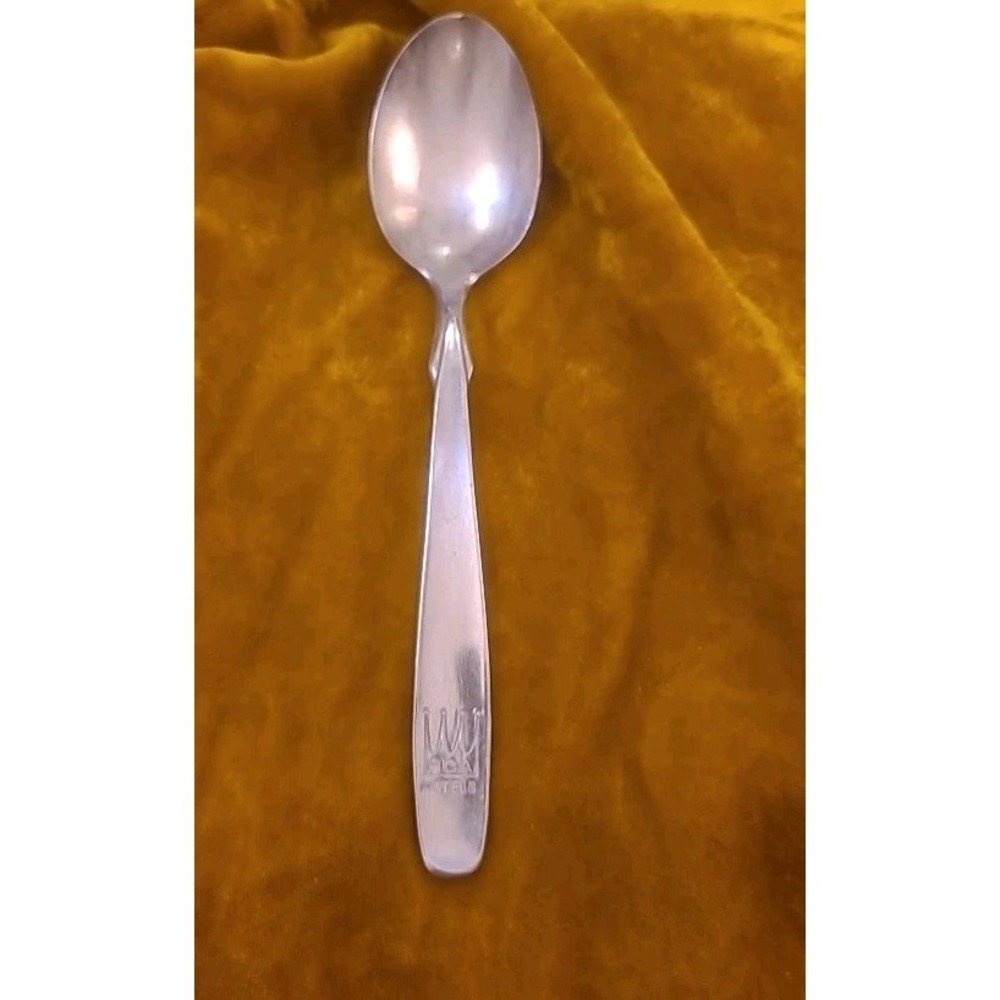 This item is a vintage silver-plated souvenir International Hotel Spoon